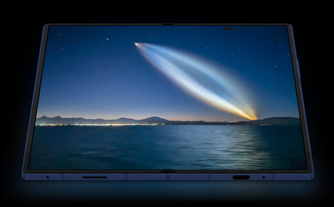 A close-up of the expansive unfolded display with a detailed image of a night sky over an ocean