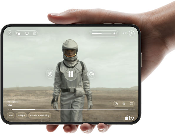 iPhone Duo, held with one hand, opened in horizontal orientation, fully unfolded, interior screen displays Apple TV show