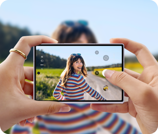 An image of someone holding the device taking a photo of a lady smiling