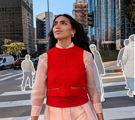 Lifestyle image of female looking left representing Magic Editor feature, against outlined images of other figures in background of city location.